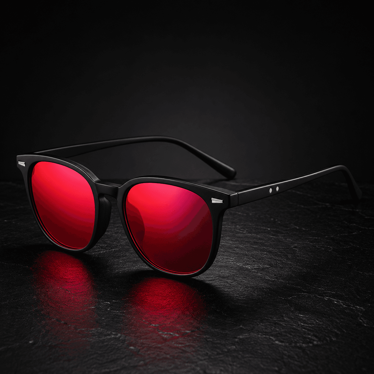 Vomando NightLens glasses with matte black frames and wine-red lenses on dark stone